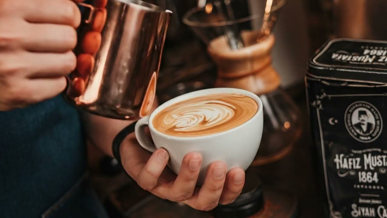 Vertido de latte art con jarra de cobre en Il Barista